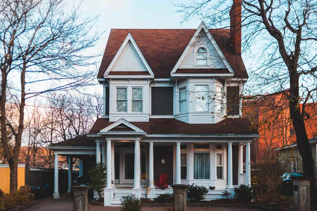 An older house with classic detailing standing among autumn foliage