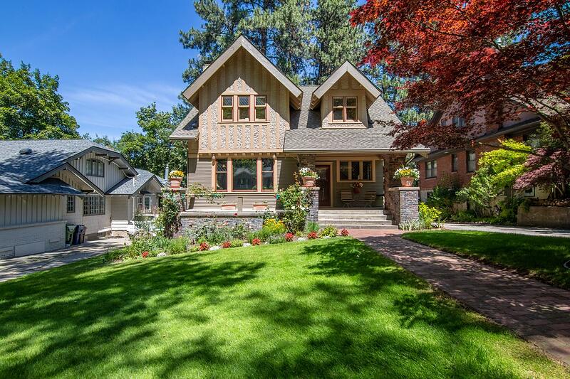 An older house with a trimmed lawn and tidy front planting